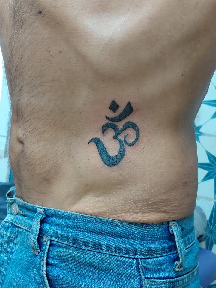 Om symbol in solid black on the belly