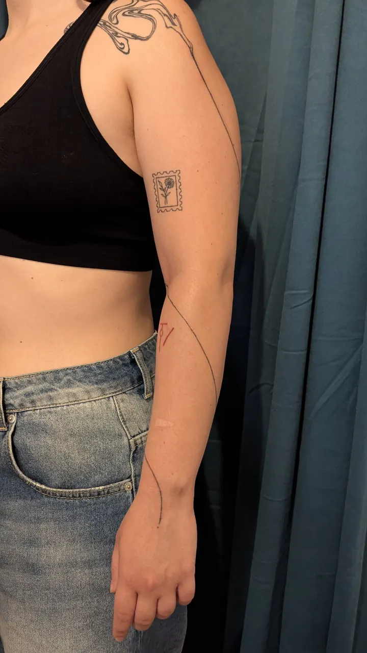 Long fine line winding down the arm