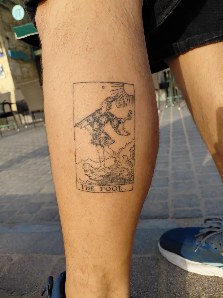 The Fool tarot card on the calf